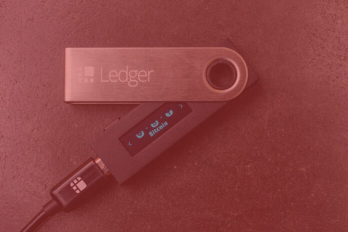 Ledger hardware wallet on a red background